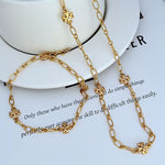 Interlocking logo chain necklace, gold-tone links with clover medallion charms