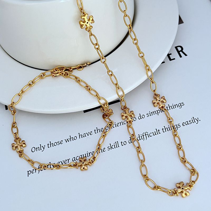 Gold-tone chain bracelet with interlocking logo link charms