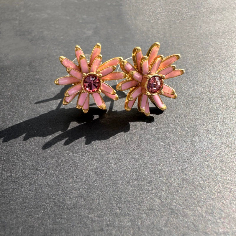 Enamel flower earrings in gold-tone with pink petals and pink center stones, stud style