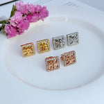 Square stud earrings shown in gold, white gold, silver, and rose gold with rhinestones