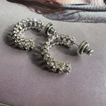 Silver-tone cubic zirconia C-hoop earrings with clear stones; stud backs shown