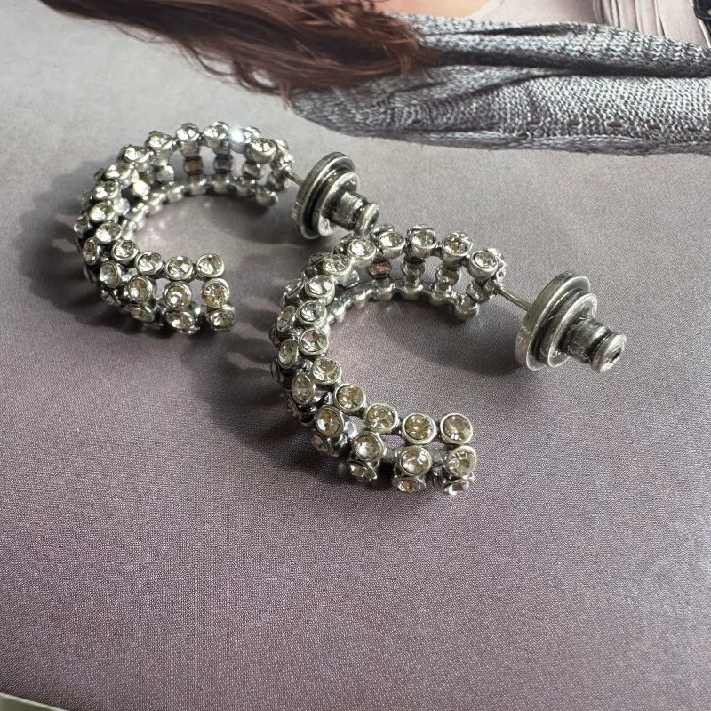 Silver-tone cubic zirconia C-hoop earrings with clear stones; stud backs shown