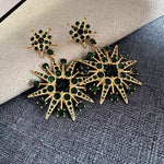 Green crystal star drop earrings, gold-tone eight-pointed stars with dark-green stones.