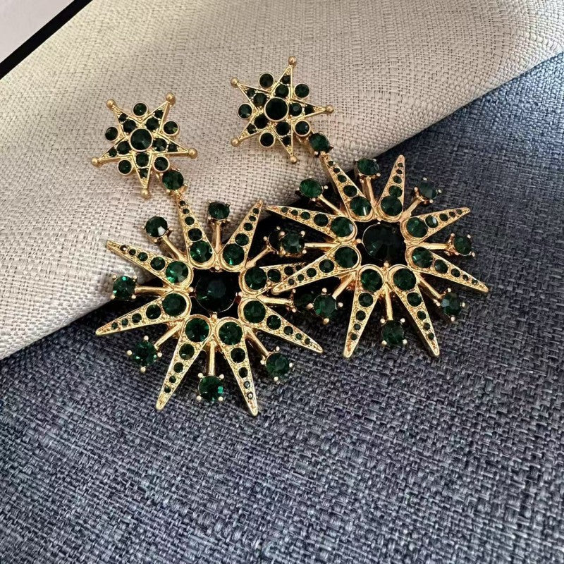 Green crystal star drop earrings, gold-tone eight-pointed stars with dark-green stones.