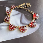 Red heart bracelet with rhinestone-look stones, gold-tone chain