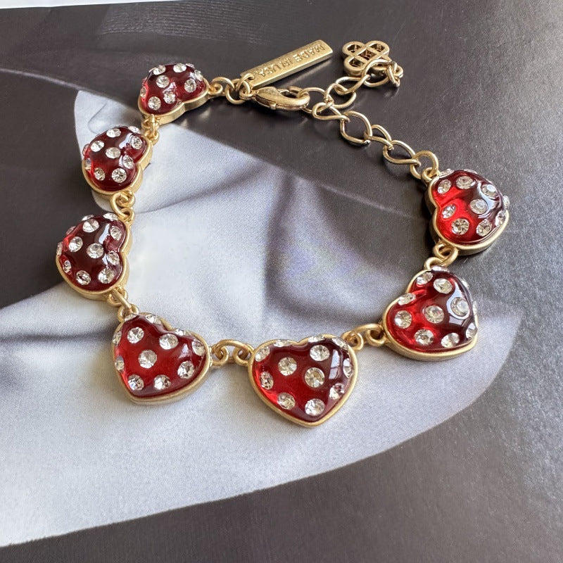 Red heart bracelet with rhinestone-look stones, gold-tone chain
