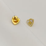 Back view of heart-shaped gold-tone metal stud earrings with posts