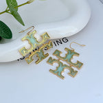Green logo drop earrings with gold-tone metal hooks