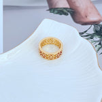 Gold wide band ring with hollow logo-style openwork pattern