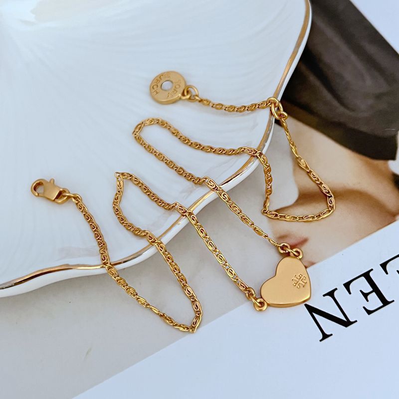 Gold heart pendant necklace with lobster clasp and heart-shaped tag
