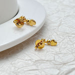 Gold-tone back view of heart and star earrings with white pearl accents