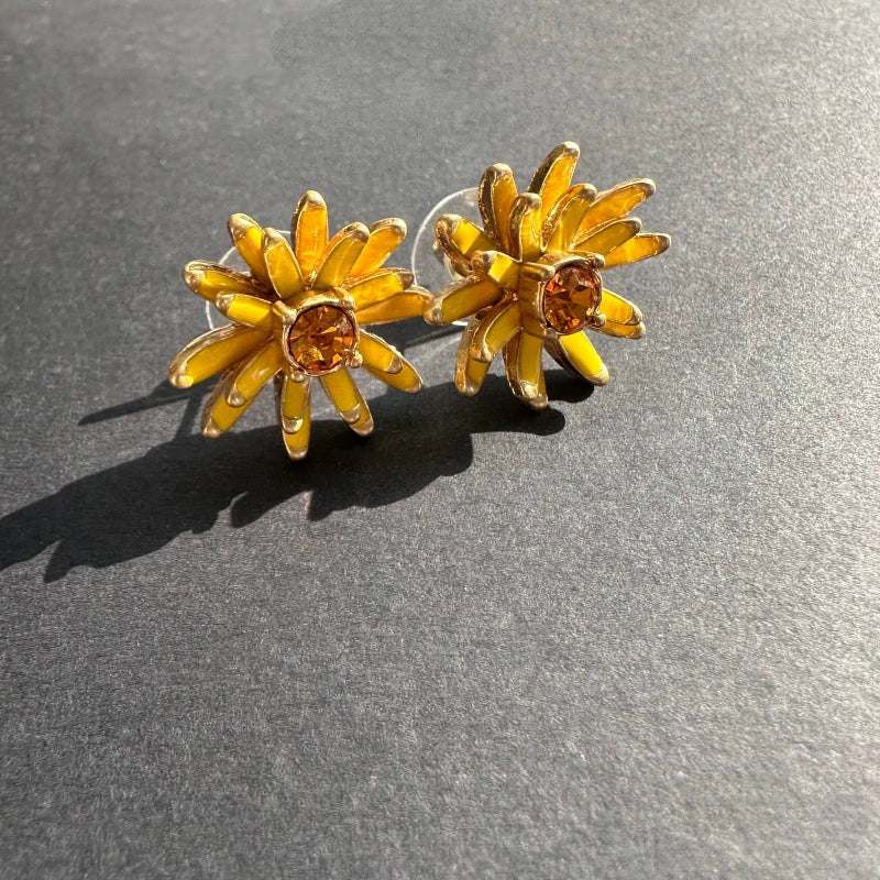 Enamel flower earrings with gold-tone yellow petals and amber center stones, stud style