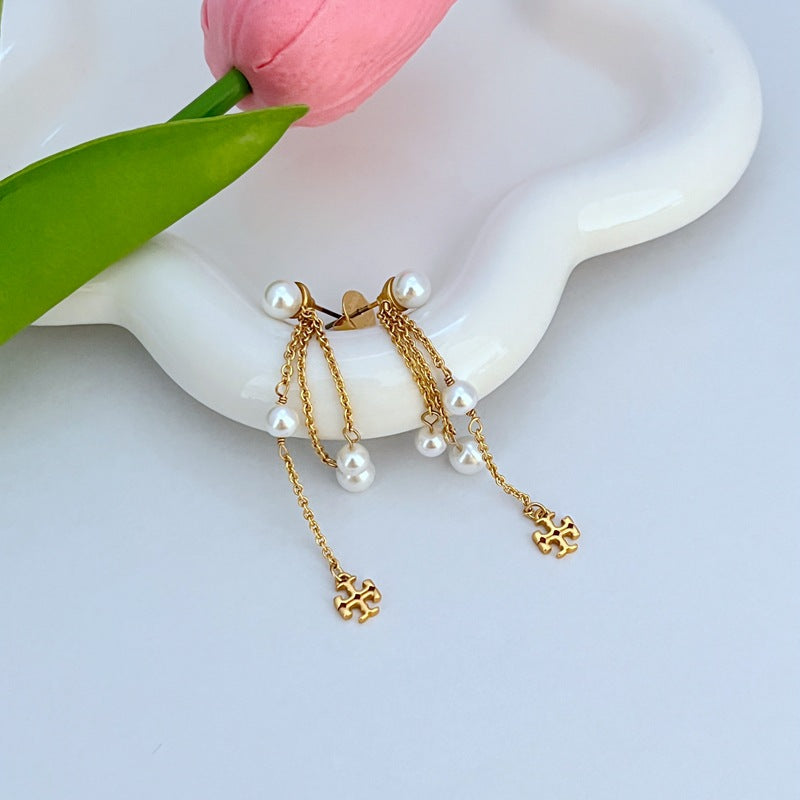 Gold-tone pearl chain tassel earrings with white pearls and logo charm dangles