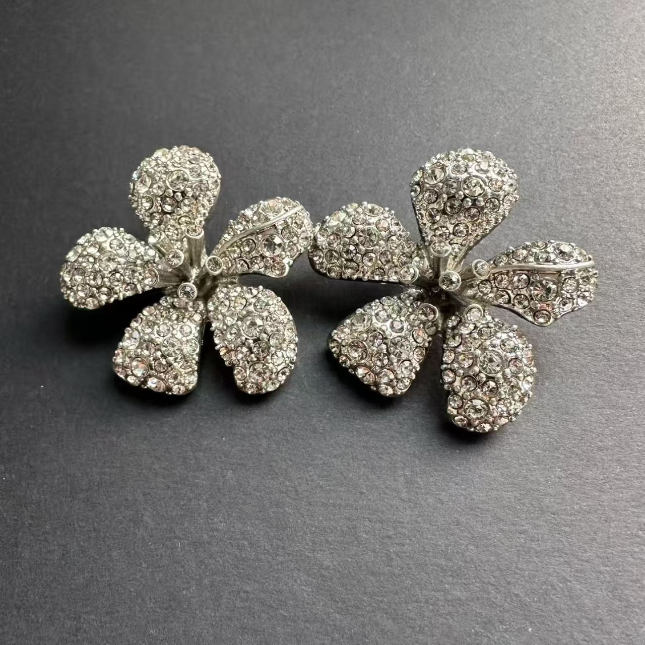 Large flower stud earrings with clear rhinestone petals, silver-tone hardware