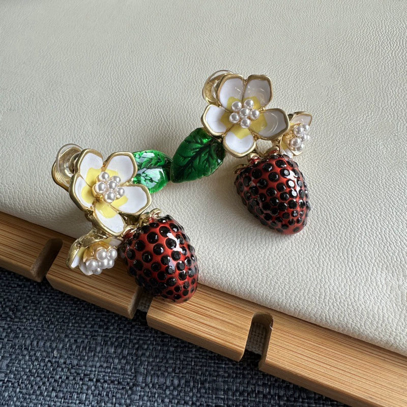 Enamel flower & strawberry clip-on earrings with green leaves, faux pearl clusters.