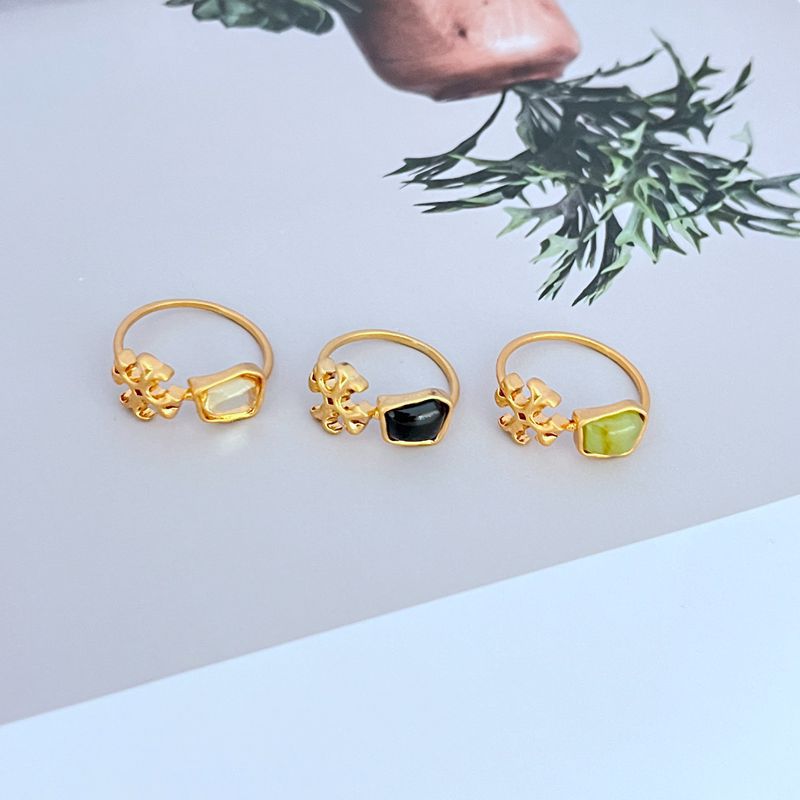 Set of three acrylic logo matte metal rings: green, black, and light green