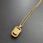 Gold-tone hammered square pendant necklace with textured back detail