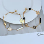 Tory Burch enamel agate logo bracelet, gold chain with black beads and round logo charm