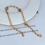 Interlocking logo chain bracelet, gold-tone oval links with clover medallion charms