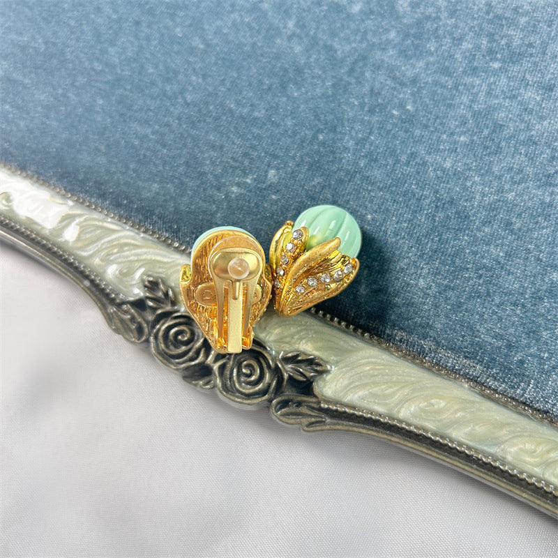 Ice-cream enamel studs, mint green domes with gold-tone bow-shaped detail