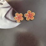 Diamond colorful floral stud earrings in gold with red stones and clear accents