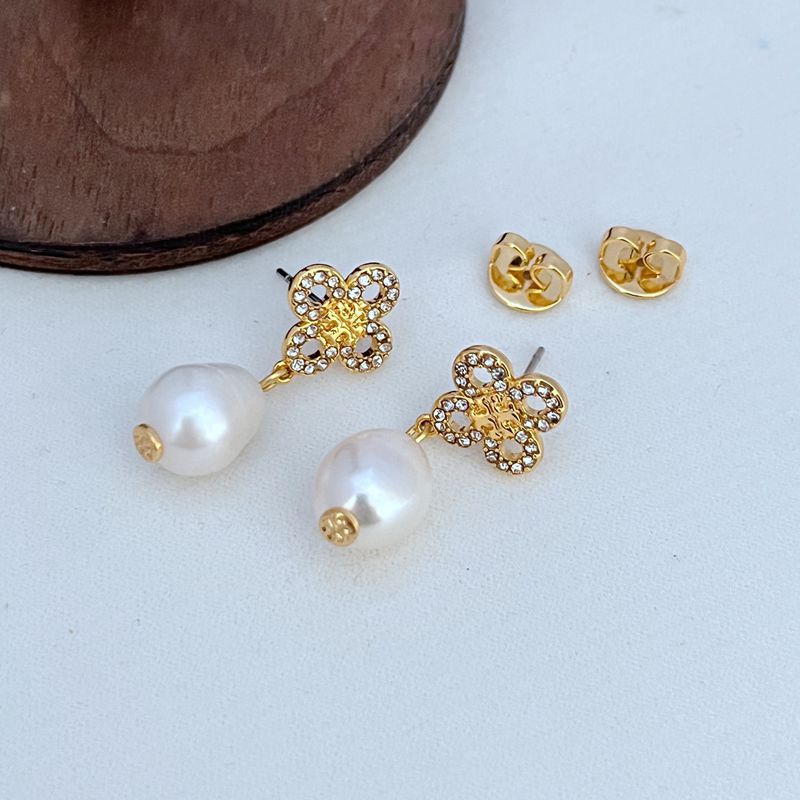 Gold four-leaf clover stud earrings with freshwater pearl and clear stone details