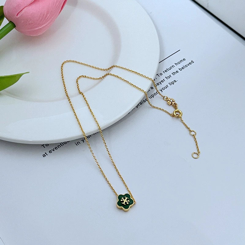 Tory Burch enamel floral pendant necklace with gold chain and green flower charm