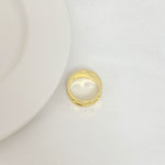 Tory Burch gold polished metal logo ring, smooth band with raised emblem
