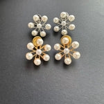 Ferris wheel pearl earrings pair: one gold-tone, one white gold-tone