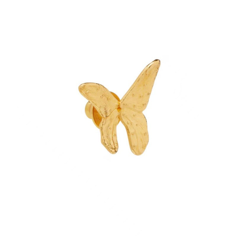 Single gold butterfly earring, angled side view with clasp