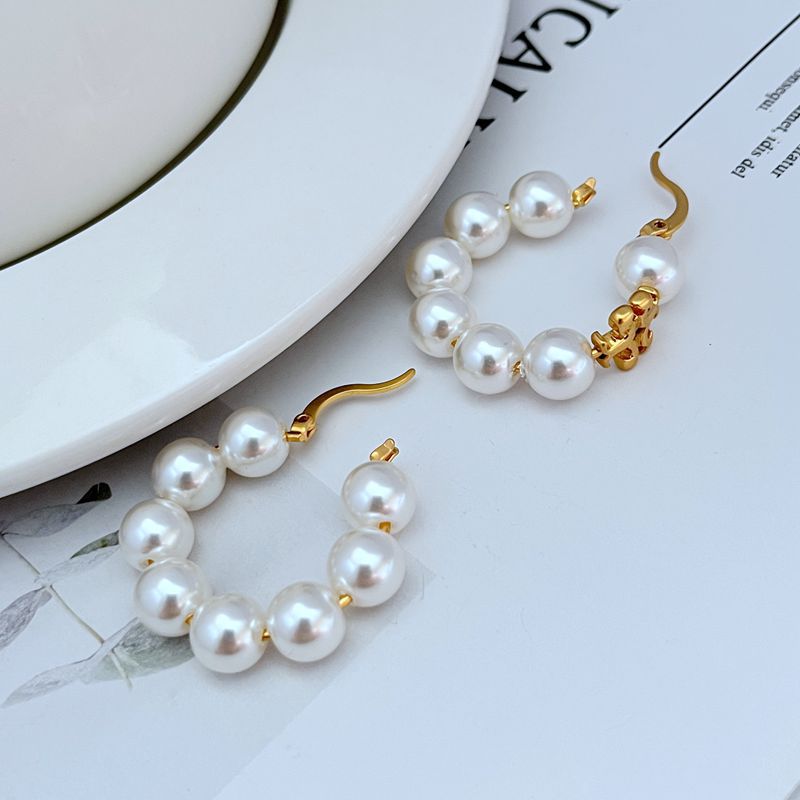 Round pearl strand hoop earrings with gold-tone hooks and stacked pearl drops