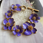 Enamel floral bracelet with gold-tone chain, purple petals, and raised bead flower centers