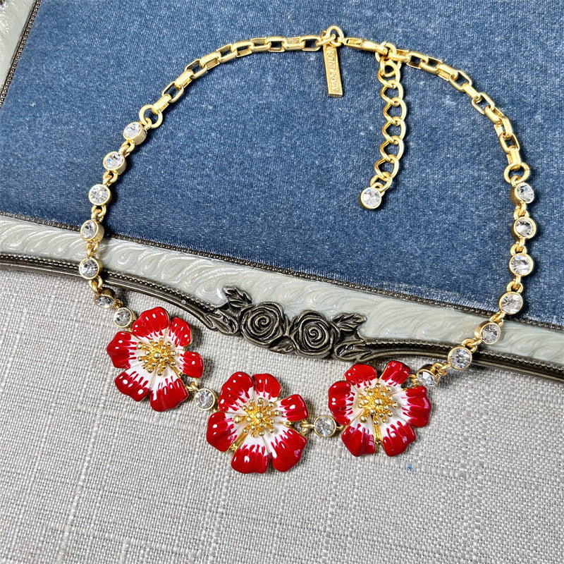 Enamel cherry blossom pendant necklace with red flowers and gold-tone chain with clear rhinestones
