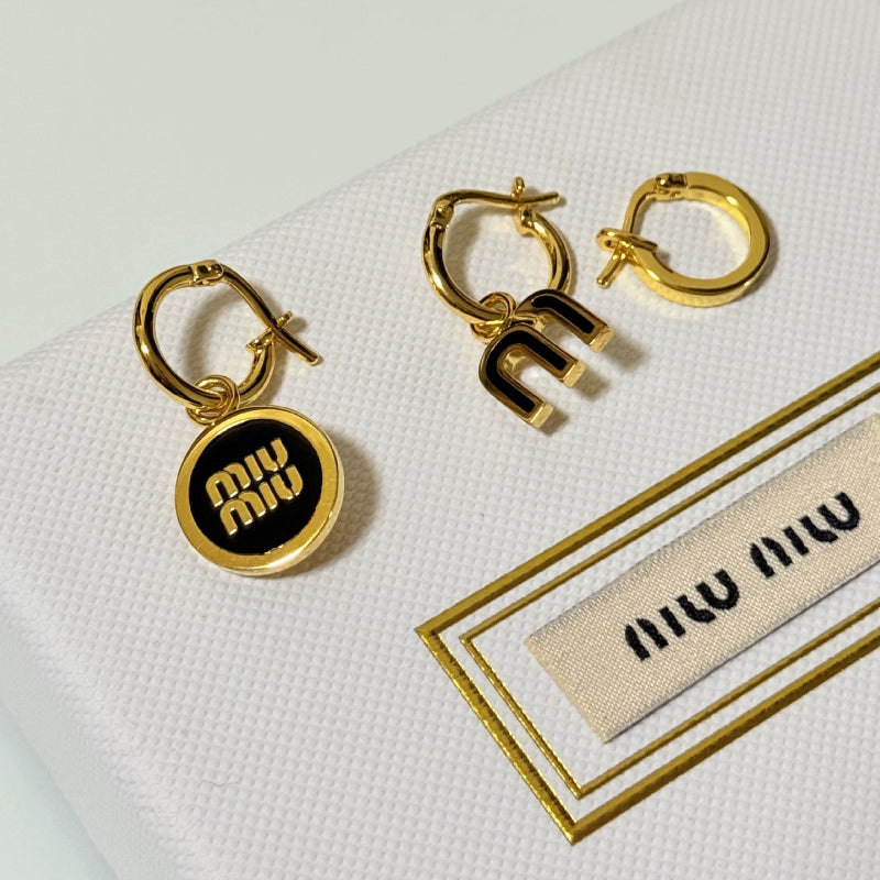 Enamel three-piece hoop earrings with black charms and gold-tone rings