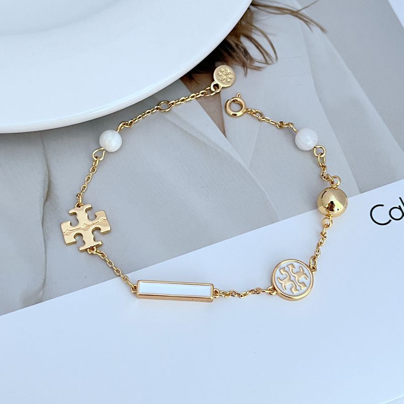 Tory Burch enamel agate logo bracelet in gold tone with white beads and puzzle charm
