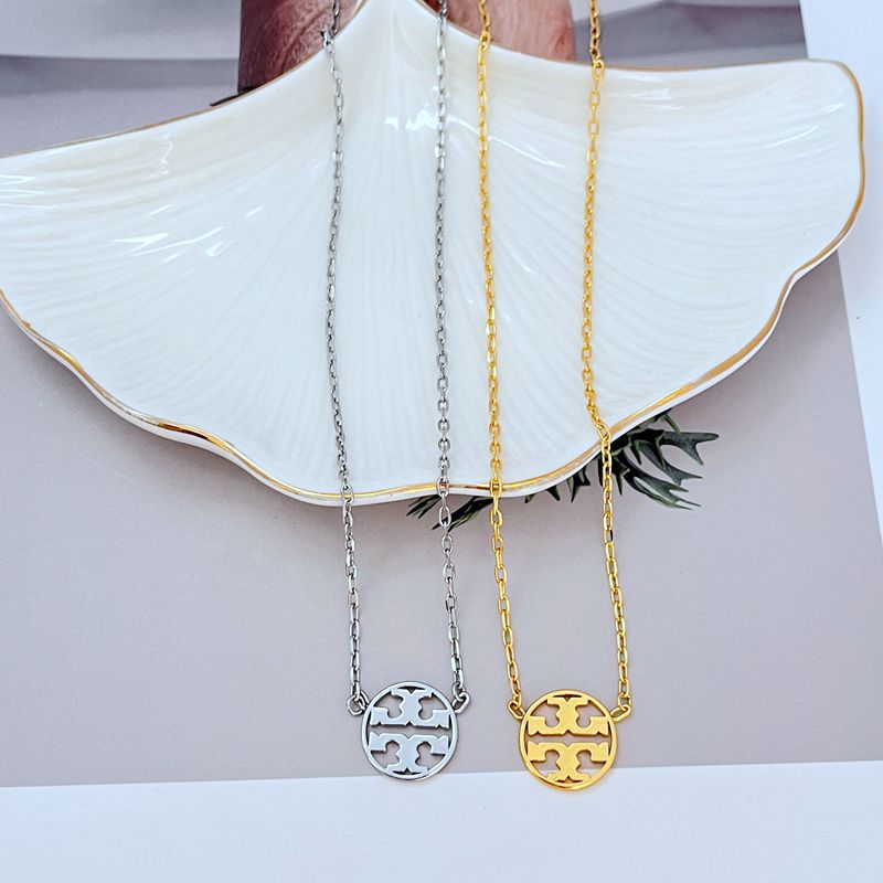 White gold and gold logo pendant necklace set with round openwork emblem on chains