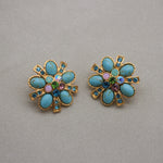 Gold-tone turquoise flower stud earrings with rainbow gemstone center and halo stones