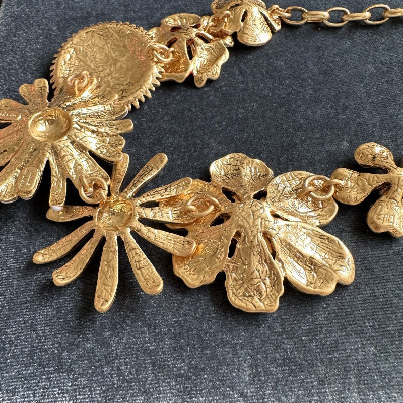 Gold-tone daisy flower necklace with chain and multiple enamel flower charms