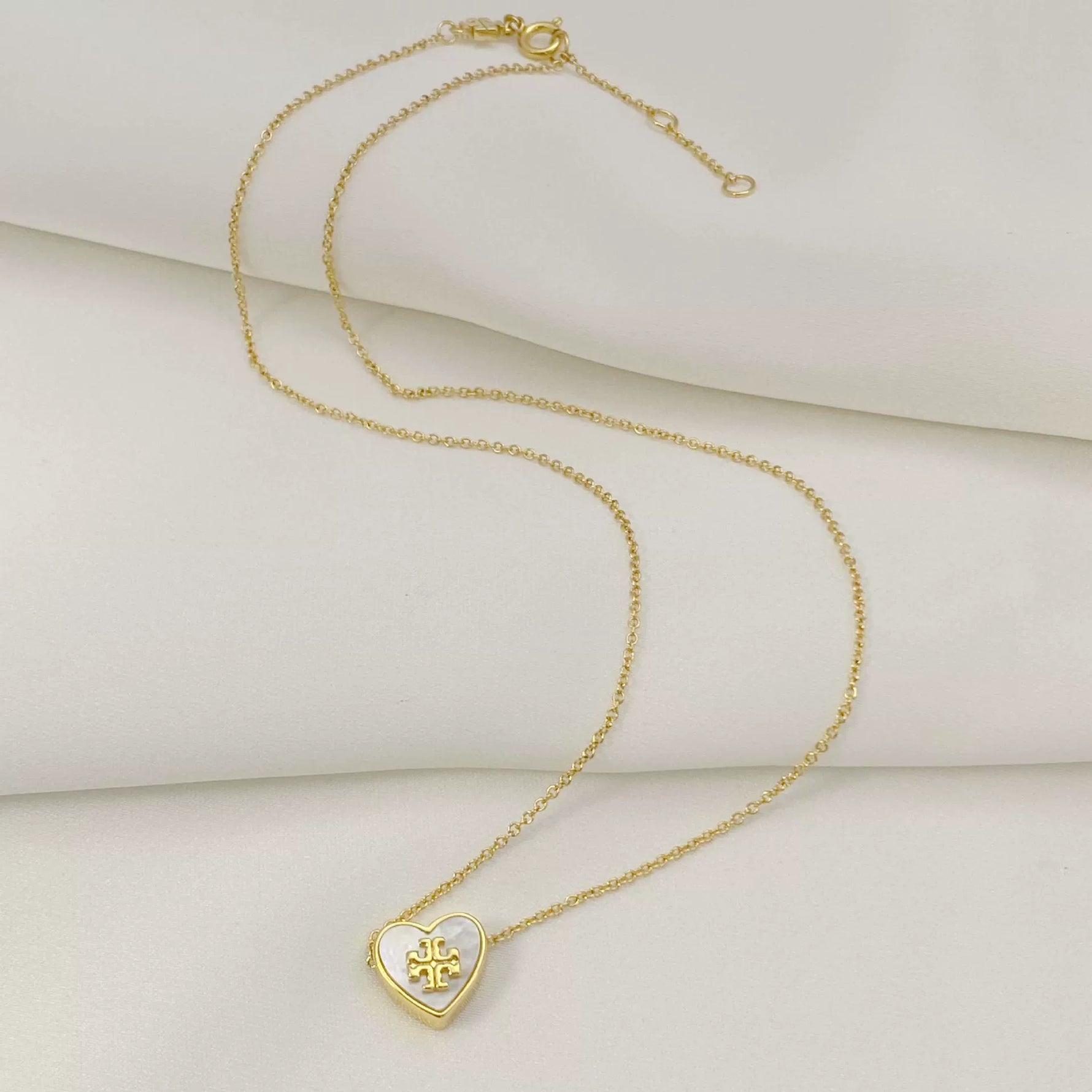 Gold-tone heart pendant necklace with mother-of-pearl detail and chain