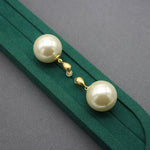 Gold faux-pearl drop earrings with large ivory spheres and chain-like gold links
