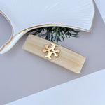 Milky White acrylic hair clip with gold logo detail