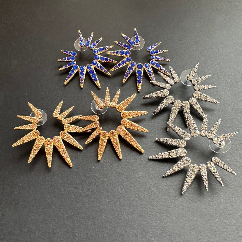 Blue and gold starburst earrings with pavé stones and circular post backs