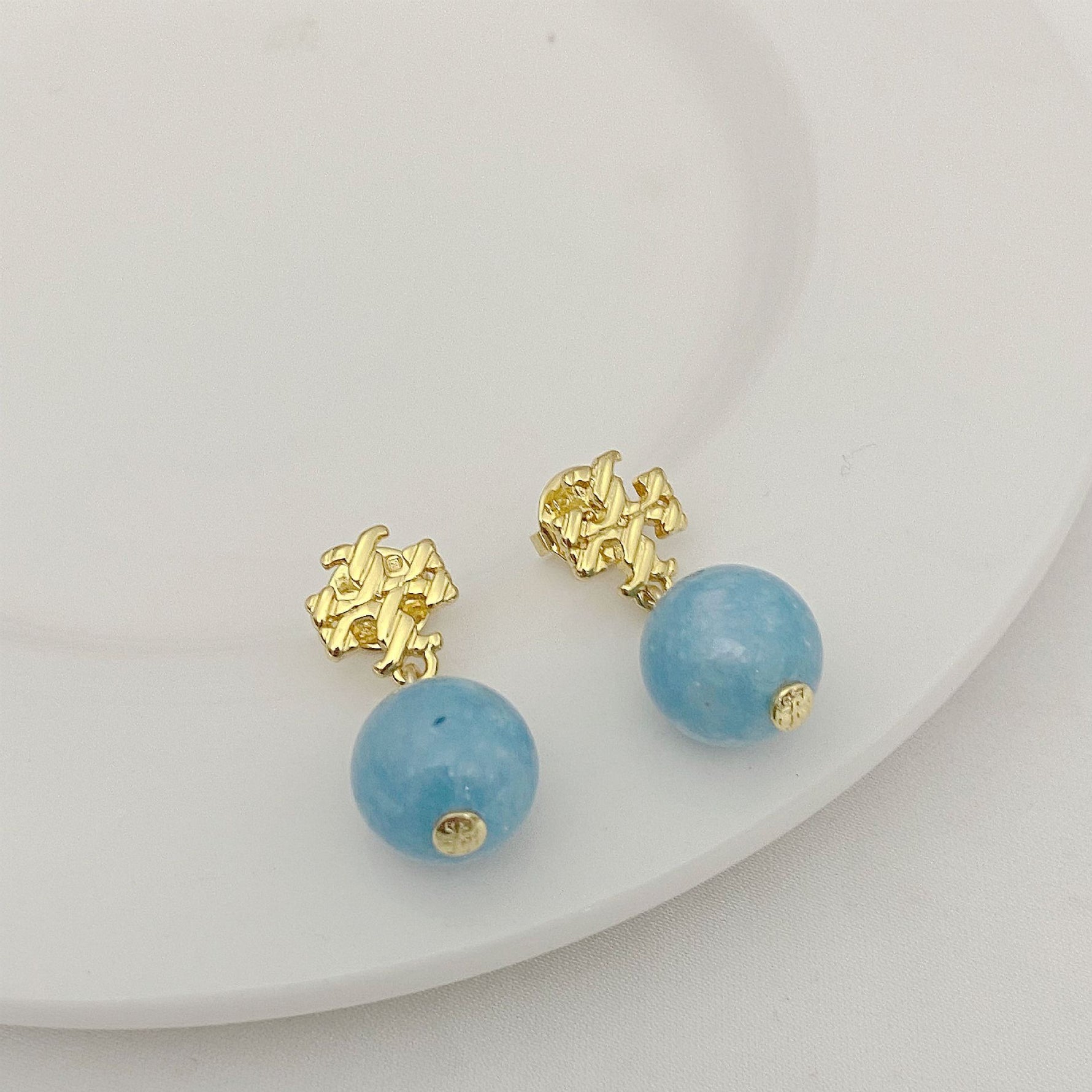 Blue agate pendant earrings with gold logo stud and round bead drop