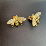 Bee earrings in gold-tone with clear crystal wings and dark enamel details