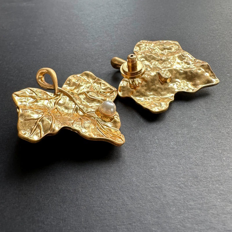 Gold-tone ivy leaf pearl stud earrings with leaf-shaped back and faux pearl