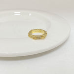 Gold-tone rhinestone ring with round bezel, centered stones on top