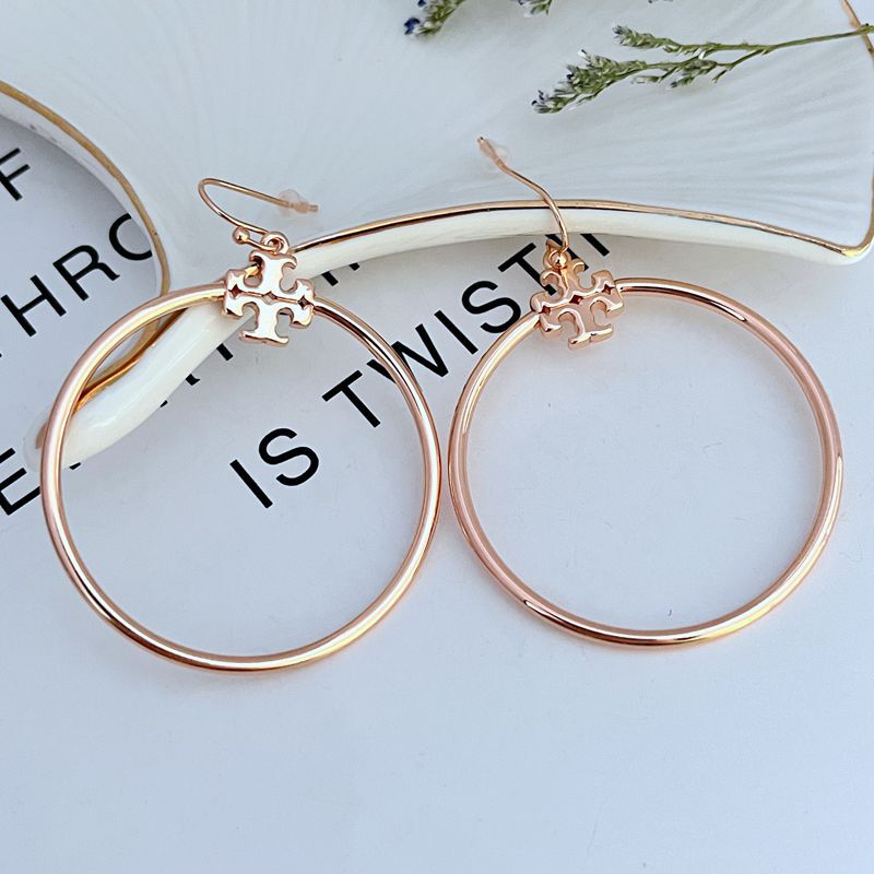 Large round rose gold hoop earrings with quatrefoil charm