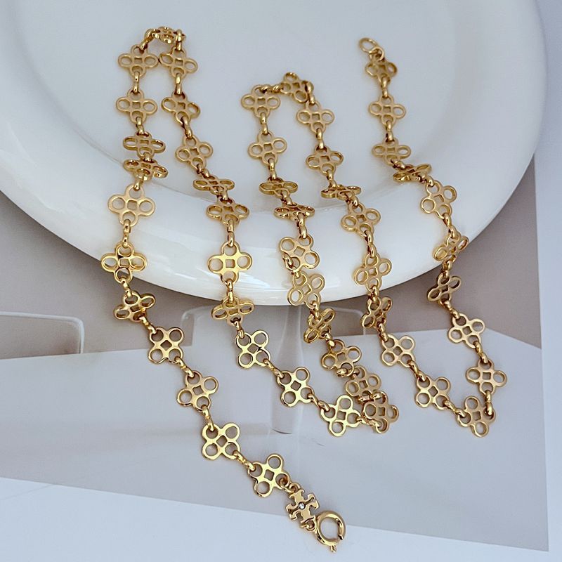 Gold four-leaf clover sweater chain with linked clover charms and clasp