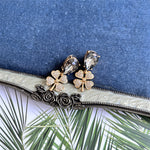 Vintage four-leaf clover earrings with clear/gray teardrop stones and gold pavé clover details