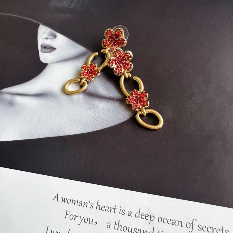 Gold floral drop earrings with red crystal clover and oval link drops